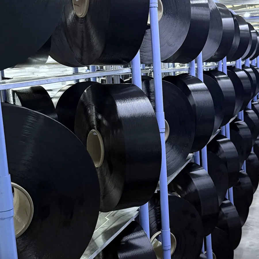 Glossy black DTY packages on the rack, close up